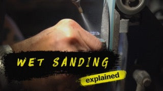 “Wet Sanding Explained” text over a hand wet-sanding a surface